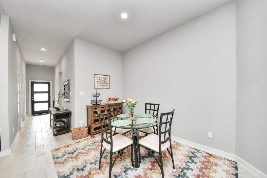 Positioned quietly off the foyer, this versatile corner serves as an intimate setting for weeknight dinners or festive gatherings.