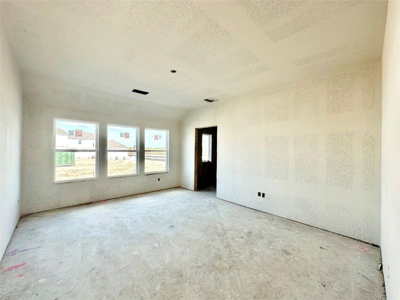 Unfurnished room featuring a textured ceiling and lofted ceiling Unfurnished room featuring a textured ceiling and lofted ceiling
