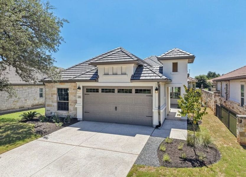 Front exterior of a new home in Cimarron Hills – Villas & Country Club, Georgetown, TX, highlighting curb appeal (Image 30).