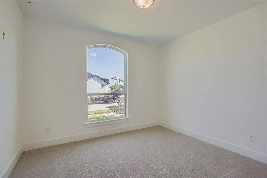 Unfurnished room with light carpet and baseboards Unfurnished room with light carpet and baseboards