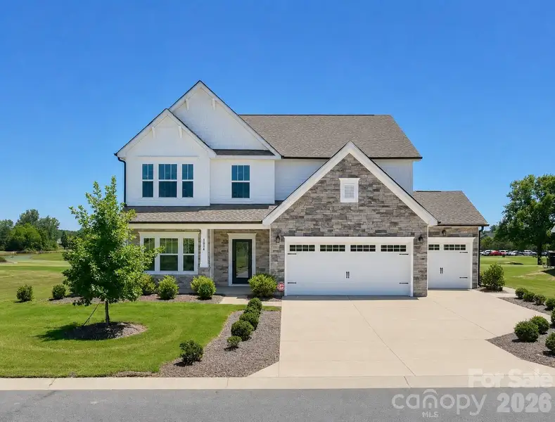 Front exterior of a new home in Stonebridge Fairways, Monroe, NC, highlighting curb appeal (Image 2). Front exterior of a new home in Stonebridge Fairways, Monroe, NC, highlighting curb appeal (Image 2).