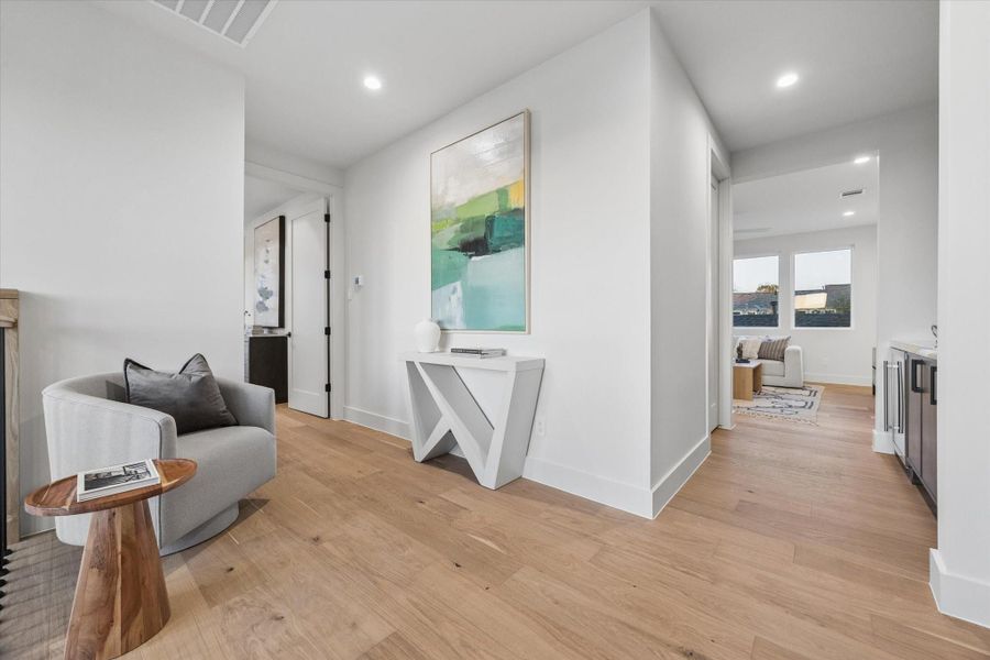 To the left is the primary suite, and straight ahead is the laundry room and game room.