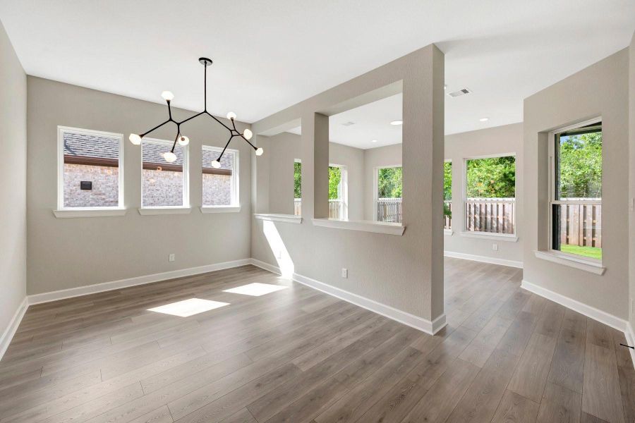 Spacious Dining area with lots of windows for light plus a Sunroom overlooking rear yard and patio
