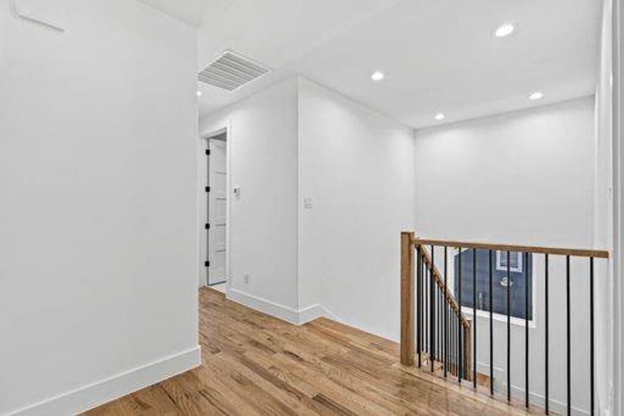 Corridor with light hardwood / wood-style flooring