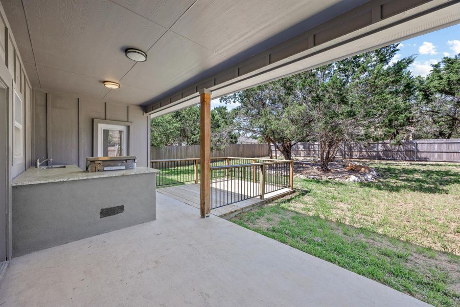 View of patio featuring a fenced backyard and a sink View of patio featuring a fenced backyard and a sink