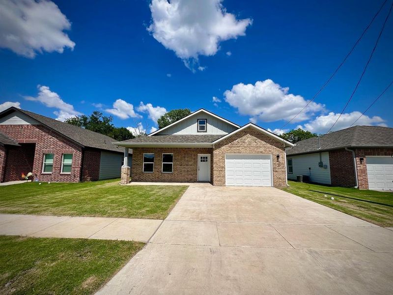 Front exterior of a new home in , Greenville, TX, highlighting curb appeal (Image 1). Front exterior of a new home in , Greenville, TX, highlighting curb appeal (Image 1).