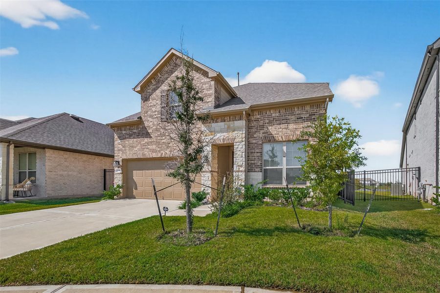 Front exterior of a new home in Sunterra, Katy, TX, highlighting curb appeal (Image 25).
