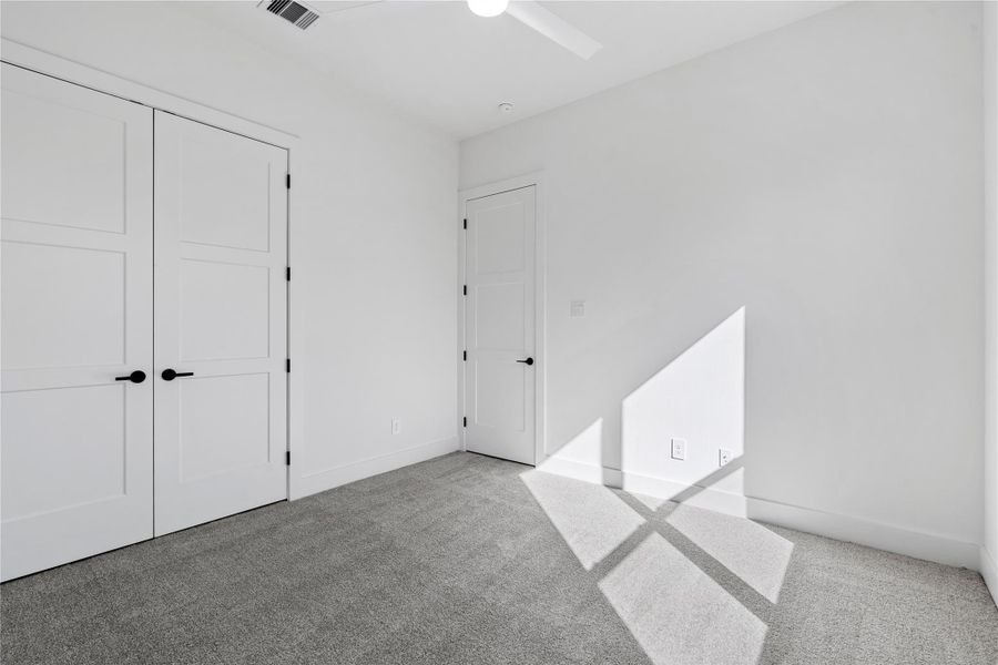 A versatile secondary bedroom offering a straightforward footprint and neutral finishes, allowing the space to adapt easily to changing needs over time.