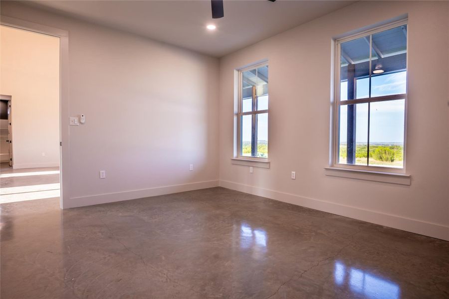 Unfurnished room featuring concrete flooring, a ceiling fan, and recessed lighting