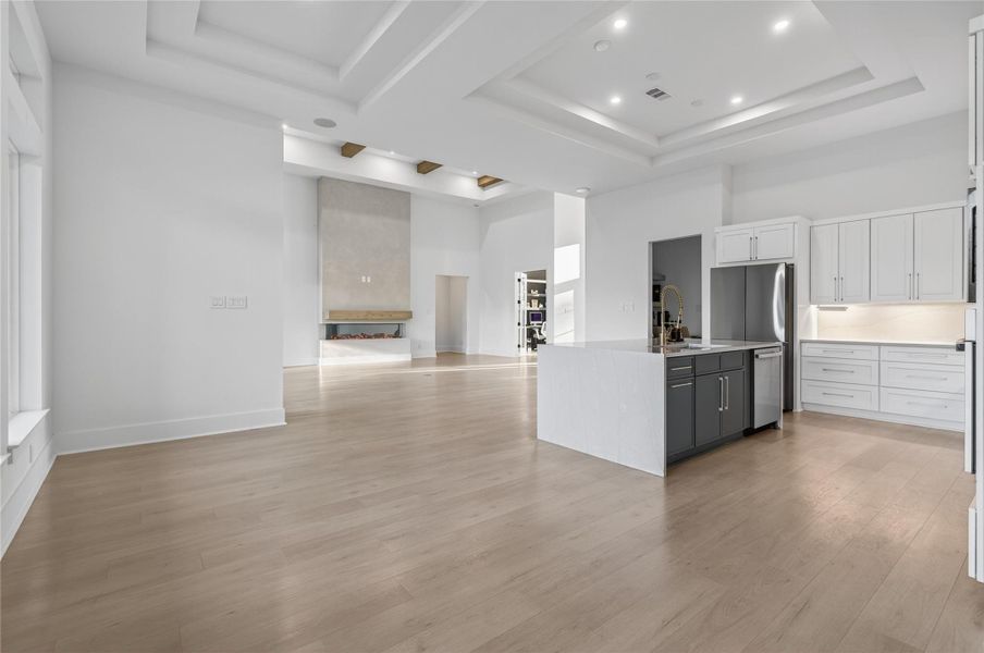 Wide view of the kitchen highlights the seamless connection to the dining and living spaces. **Images are from a previously completed project. **