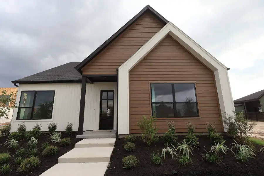 Front exterior of a new home in Bridgeland Central: Emerald Heights - Enclave Row Collection, Cypress, TX, highlighting curb appeal (Image 12). Front exterior of a new home in Bridgeland Central: Emerald Heights - Enclave Row Collection, Cypress, TX, highlighting curb appeal (Image 12).