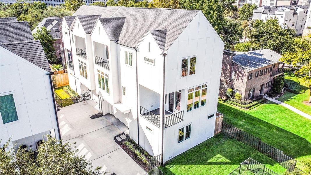 A stunning architectural perspective showcasing the modern gabled design, contrasting black railing details, and multiple balconies that define this luxury residence. The dual-driveway layout ensures privacy and ease of access while highlighting thoughtful urban planning and craftsmanship.