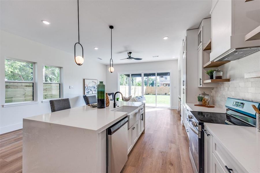 Kitchen with appliances with stainless steel finishes, ceiling fan, light wood-style floors, open shelves, and recessed lighting Kitchen with appliances with stainless steel finishes, ceiling fan, light wood-style floors, open shelves, and recessed lighting