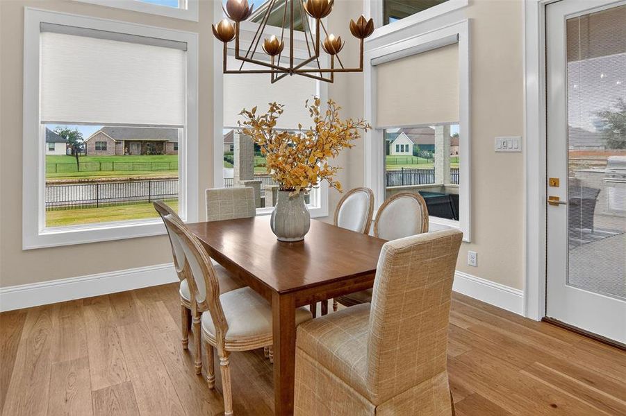 Dining area featuring light wood-type flooring and a chandelier