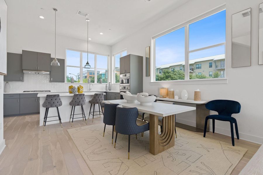 Dining area featuring light wood finished floors and recessed lighting
