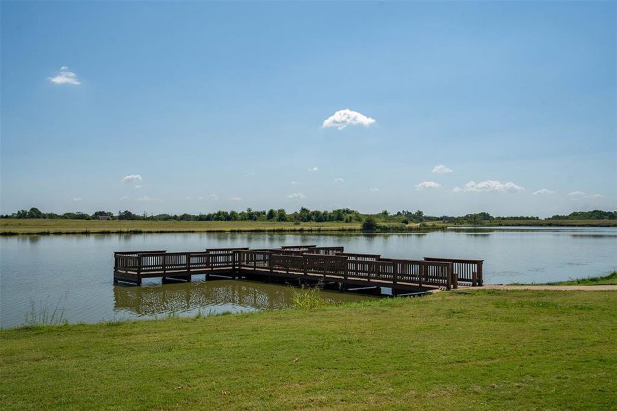 Dock area featuring a lawn and a water view Dock area featuring a lawn and a water view