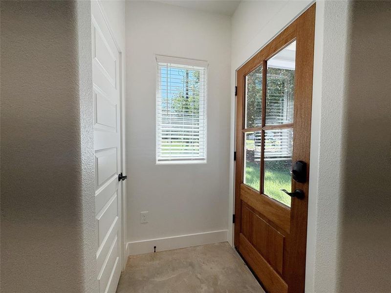 Doorway featuring baseboards