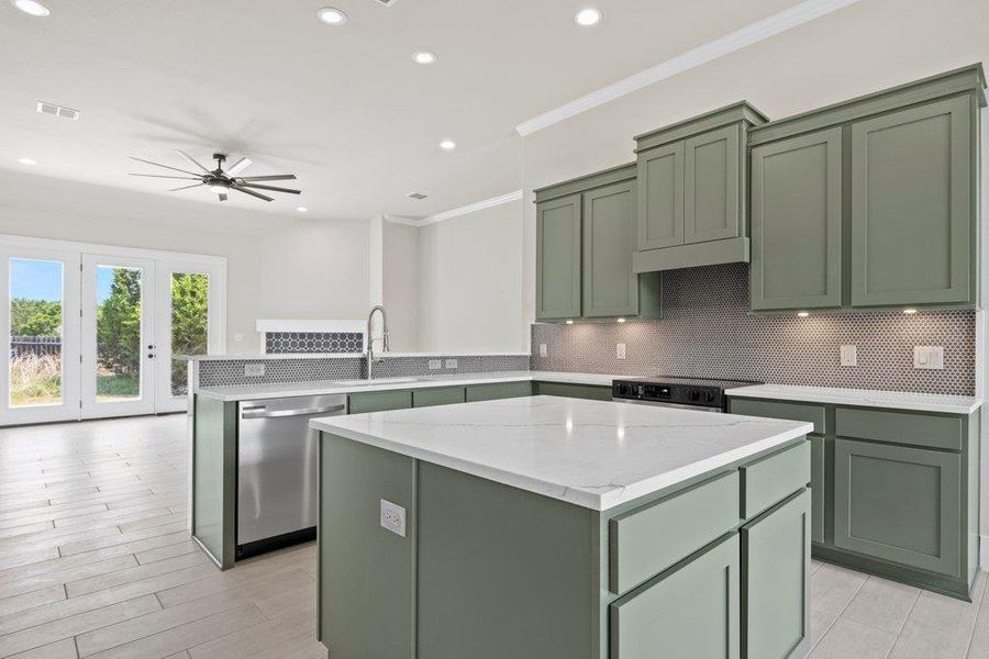 Kitchen with green cabinets, dishwasher, black electric range, a sink, and a center island Kitchen with green cabinets, dishwasher, black electric range, a sink, and a center island