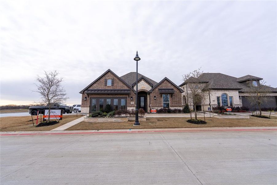 Front exterior of a new home in , Little Elm, TX, highlighting curb appeal (Image 1). Front exterior of a new home in , Little Elm, TX, highlighting curb appeal (Image 1).