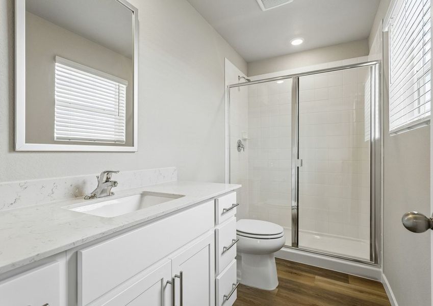 The master bathroom has a large vanity and step in shower