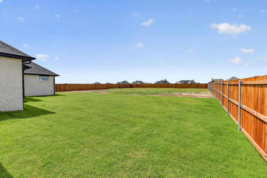 Front exterior of a new home in Coyote Crossing, Godley, TX, highlighting curb appeal (Image 22).