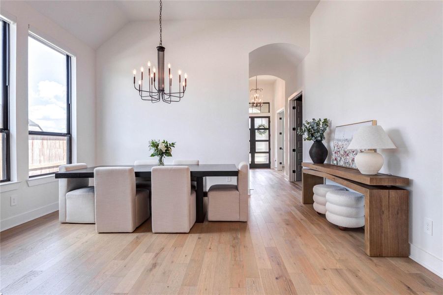 This photo showcases a bright entryway featuring modern, glass-paneled double doors with decorative wreaths. Adjacent is a set of mirrored closet doors. The space has hardwood flooring and a clean, contemporary design. This photo showcases a bright entryway featuring modern, glass-paneled double doors with decorative wreaths. Adjacent is a set of mirrored closet doors. The space has hardwood flooring and a clean, contemporary design.