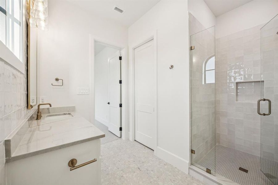 Bathroom with vanity and a stall shower Bathroom with vanity and a stall shower