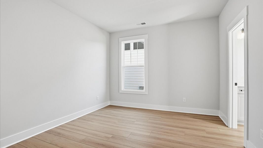 Superior hardwood flooring enhances the comfort and style of this secondary bedroom located at Benjamin's Grove Superior hardwood flooring enhances the comfort and style of this secondary bedroom located at Benjamin's Grove