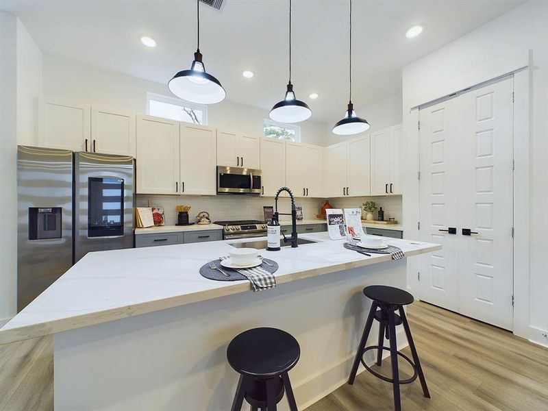 This attractive Kitchen is full of beautiful details. Quartz Countertops, Stainless Sink, Stainless Steel Appliances, Recessed Lighting, Undercabinet Lighting, lots of Cabinetry with Soft Close Drawers and Doors