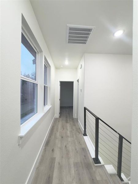 Corridor featuring light wood-type flooring