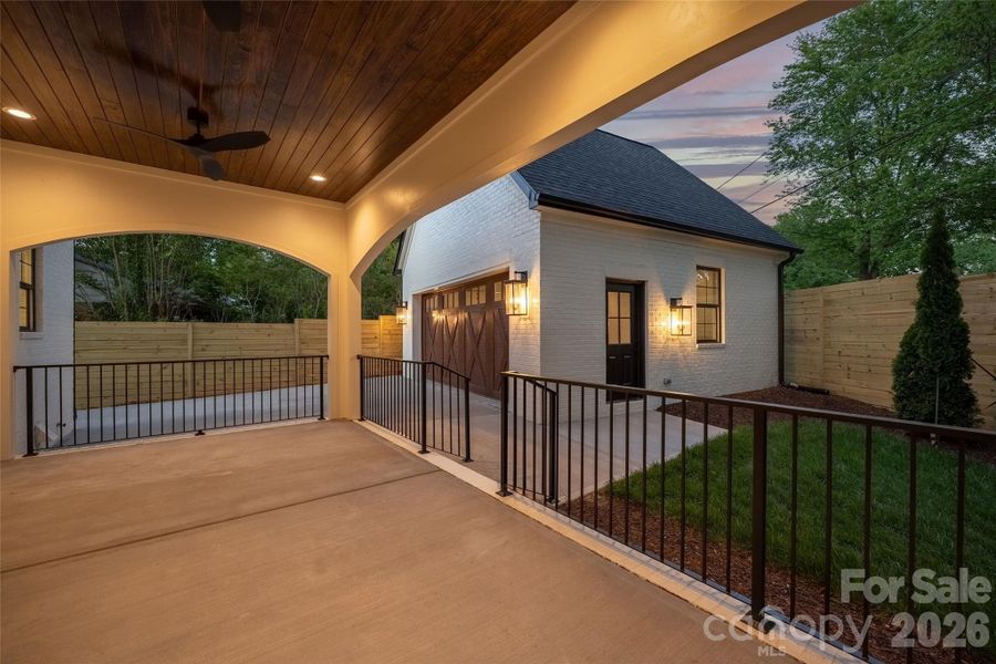 Rear patio and detached garage at twilight.