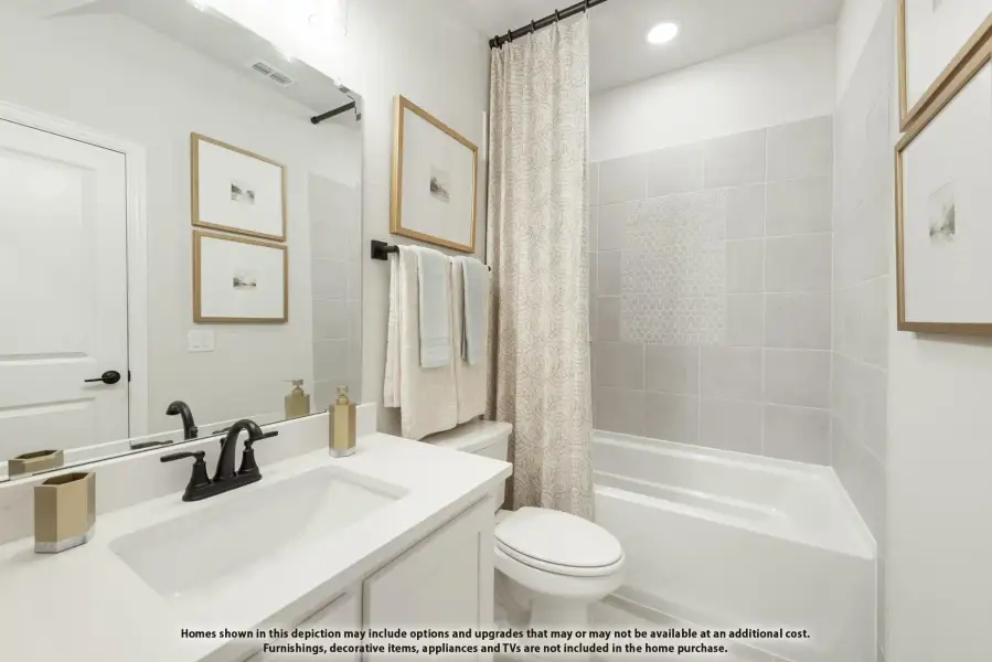 Bathroom with white vanity, tub-shower combo with gray tile surround, and large mirror Bathroom with white vanity, tub-shower combo with gray tile surround, and large mirror