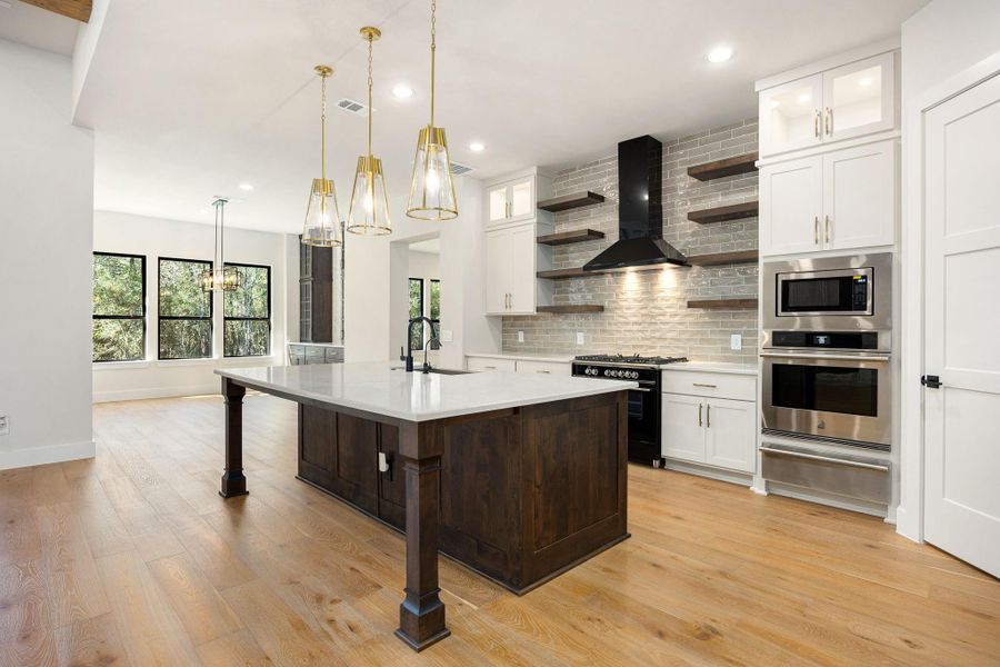Open island Kitchen with stainless steel appliances and floating shelves Open island Kitchen with stainless steel appliances and floating shelves