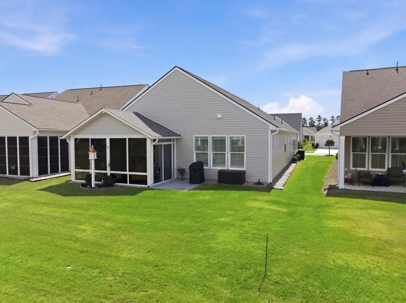 Exterior details and patio area of a home in K. Hovnanian's® Four Seasons at Lakes of Cane Bay, Summerville (Image 4).