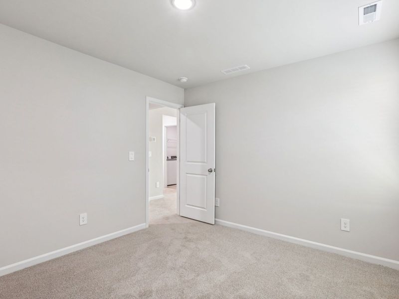 Secondary bedroom in the Paisley floorplan at a Meritage Homes community in Garner, NC.