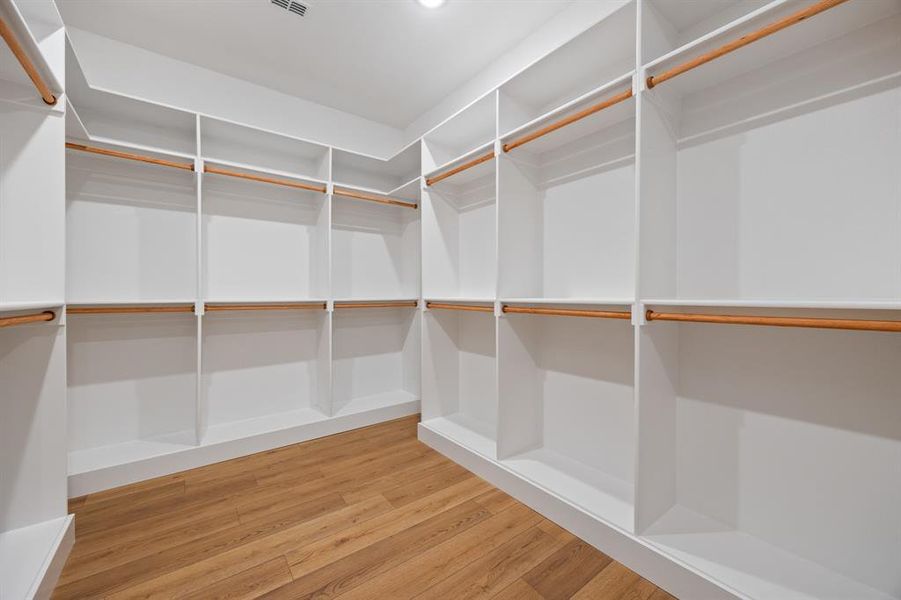 Spacious closet with light wood-type flooring