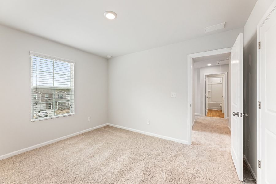 A room with a carpet and a door. A room with a carpet and a door.