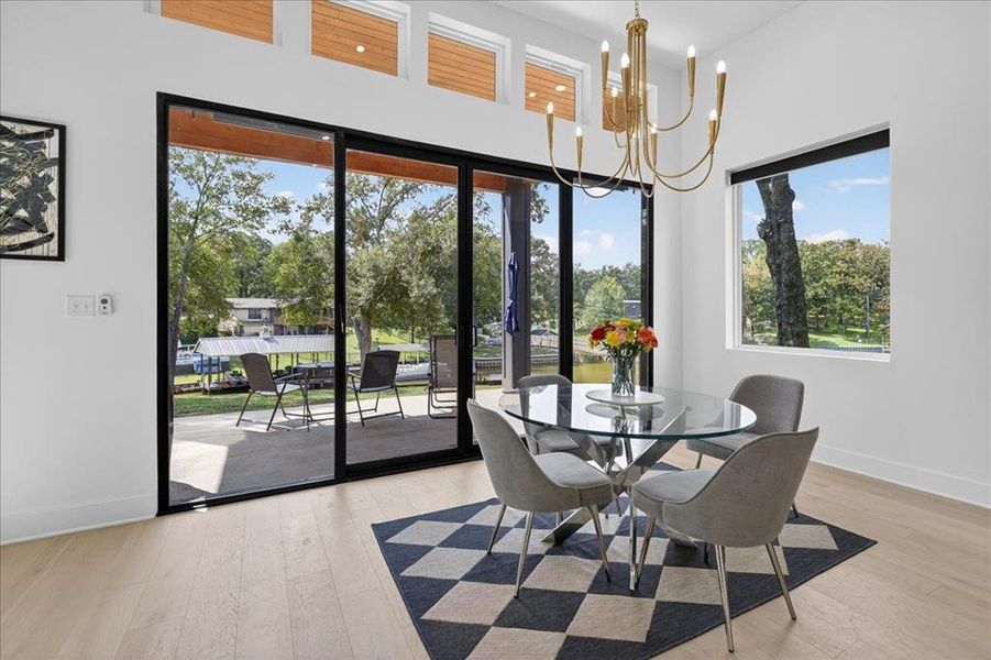 Dining area seamlessly connects to the oversized patio through expansive accordion glass doors