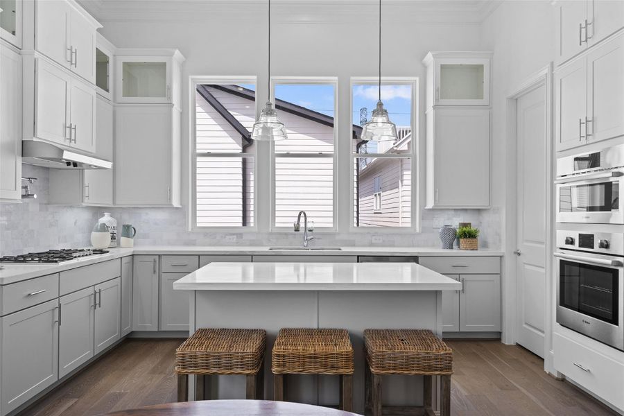 Fantastic Kitchen w/all the Natural Light. European Style Cabinets that are soft close. Stacked Cabinets on Top  to Highlight those 12 FT Ceilings.