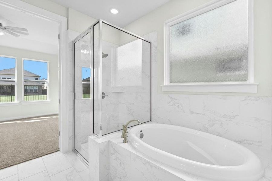 Bathroom with a bath, a marble finish shower, carpet flooring, marble look tiles, and recessed lighting