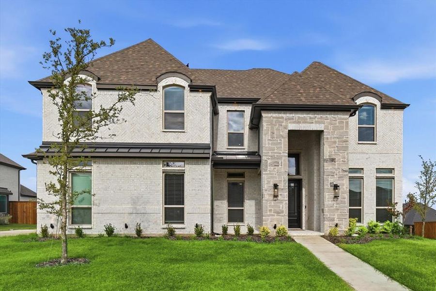 Front exterior of a new home in Cambridge Estates - Harwood, Prosper, TX, highlighting curb appeal (Image 2). Front exterior of a new home in Cambridge Estates - Harwood, Prosper, TX, highlighting curb appeal (Image 2).
