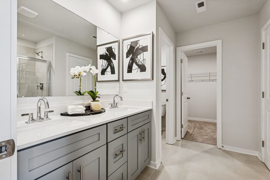 A bathroom with a large mirror. A bathroom with a large mirror.