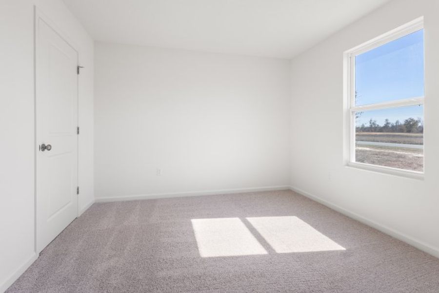 A room with a window and a rug in it. A room with a window and a rug in it.