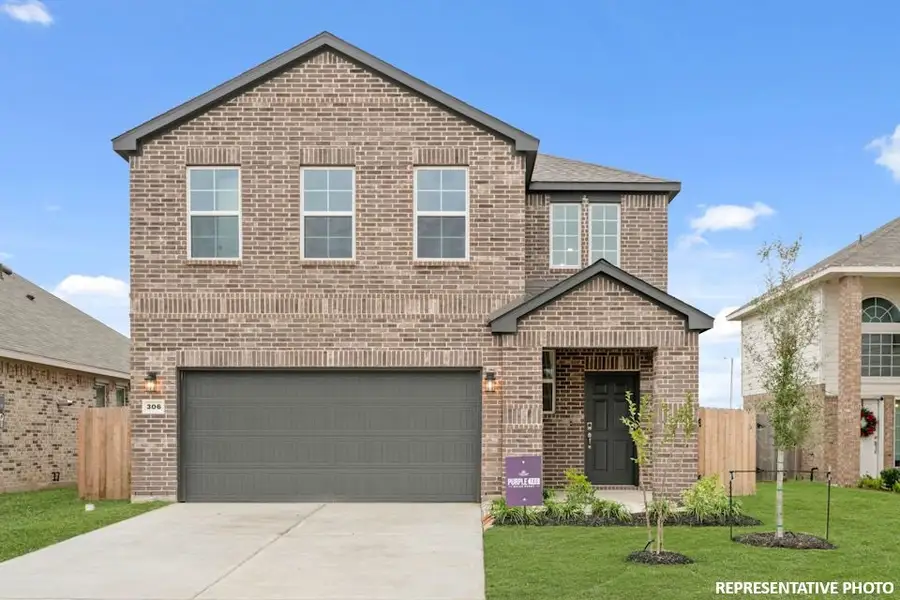 A brick house with a garage. A brick house with a garage.