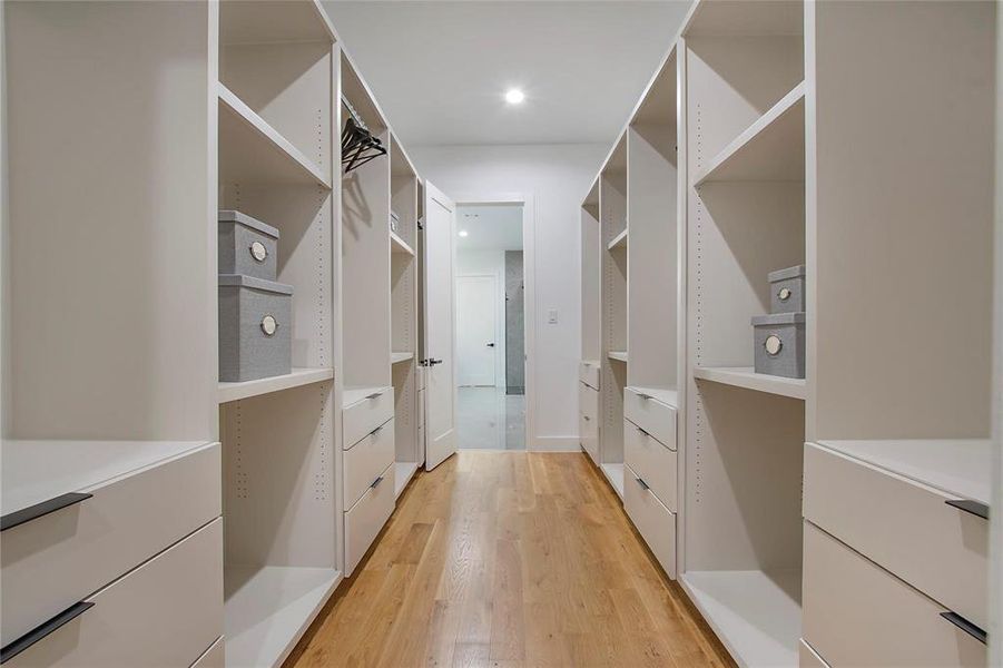 Walk in closet with light wood finished floors Walk in closet with light wood finished floors