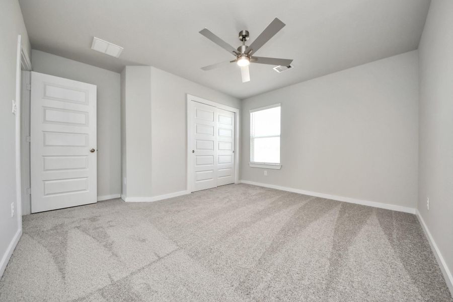 Generously sized secondary bedrooms featuring spacious closets, soft and inviting carpeting underfoot, large windows allowing plenty of natural light, and the added touch of privacy blinds for your personal retreat. Sample photo of completed home with similar floor plan. Actual colors and selections may vary.