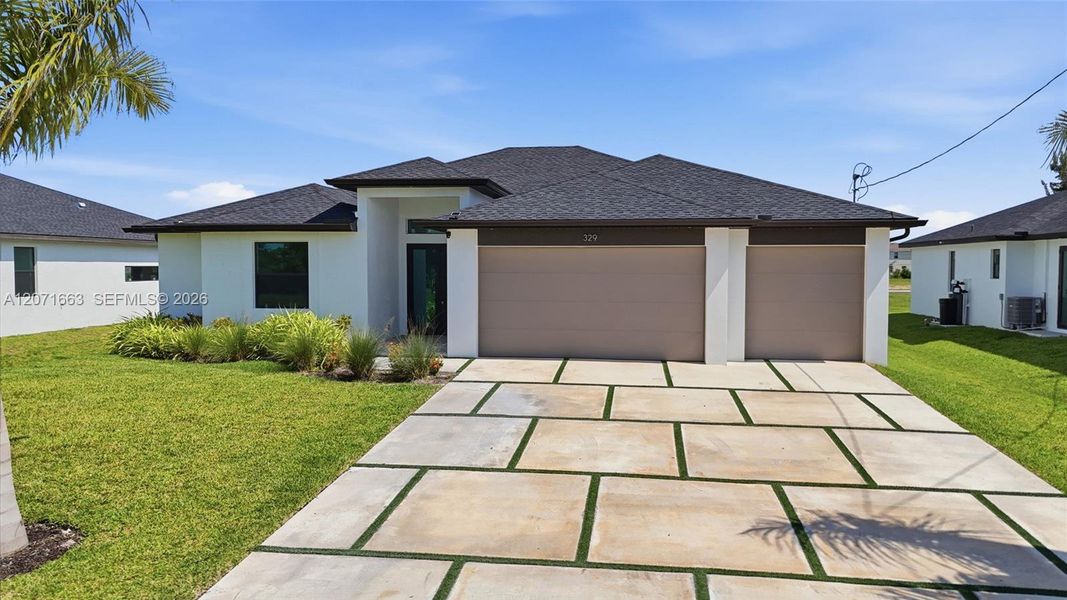 Front exterior of a new home in , Cape Coral, FL, highlighting curb appeal (Image 1). Front exterior of a new home in , Cape Coral, FL, highlighting curb appeal (Image 1).