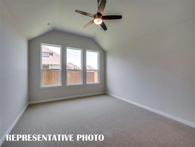 A wall of windows provides a peaceful and relaxing back yard view in this owner's suite.  REPRESENTATIVE PHOTO