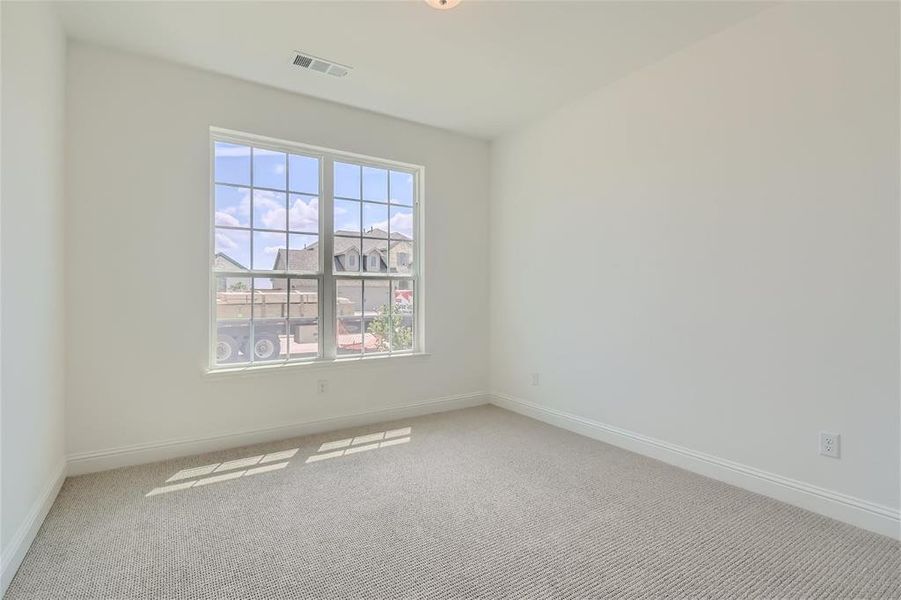 Spare room with a wealth of natural light and carpet floors