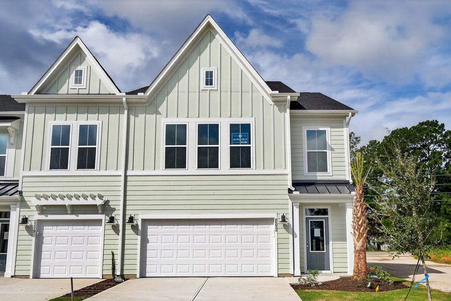 Front exterior of a new home in Grand Park, Leland, NC, highlighting curb appeal (Image 1).